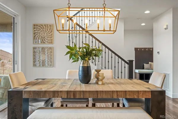 a kitchen with a dining table chairs stainless steel appliances and cabinets
