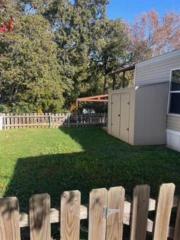 a view of a table and chairs in back yard