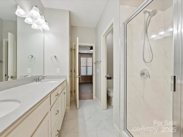 a spacious bathroom with a shower sink and mirror
