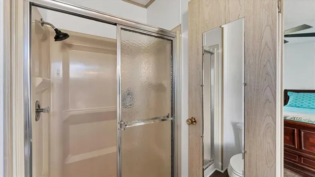 a bathroom with a glass shower door