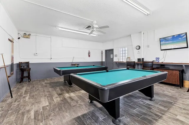 a room with pool table and windows
