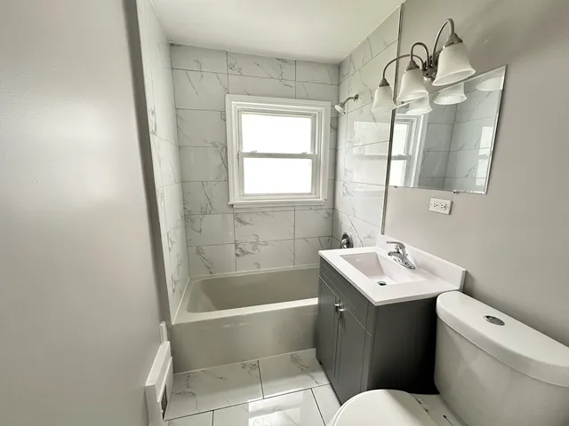 a bathroom with a sink a toilet and bathtub