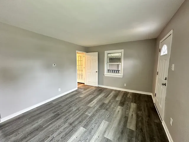 wooden floor in an empty room with a window