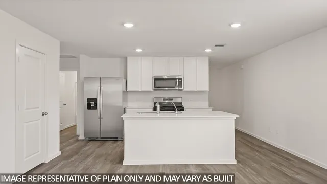 a utility room with stainless steel appliances wooden floor