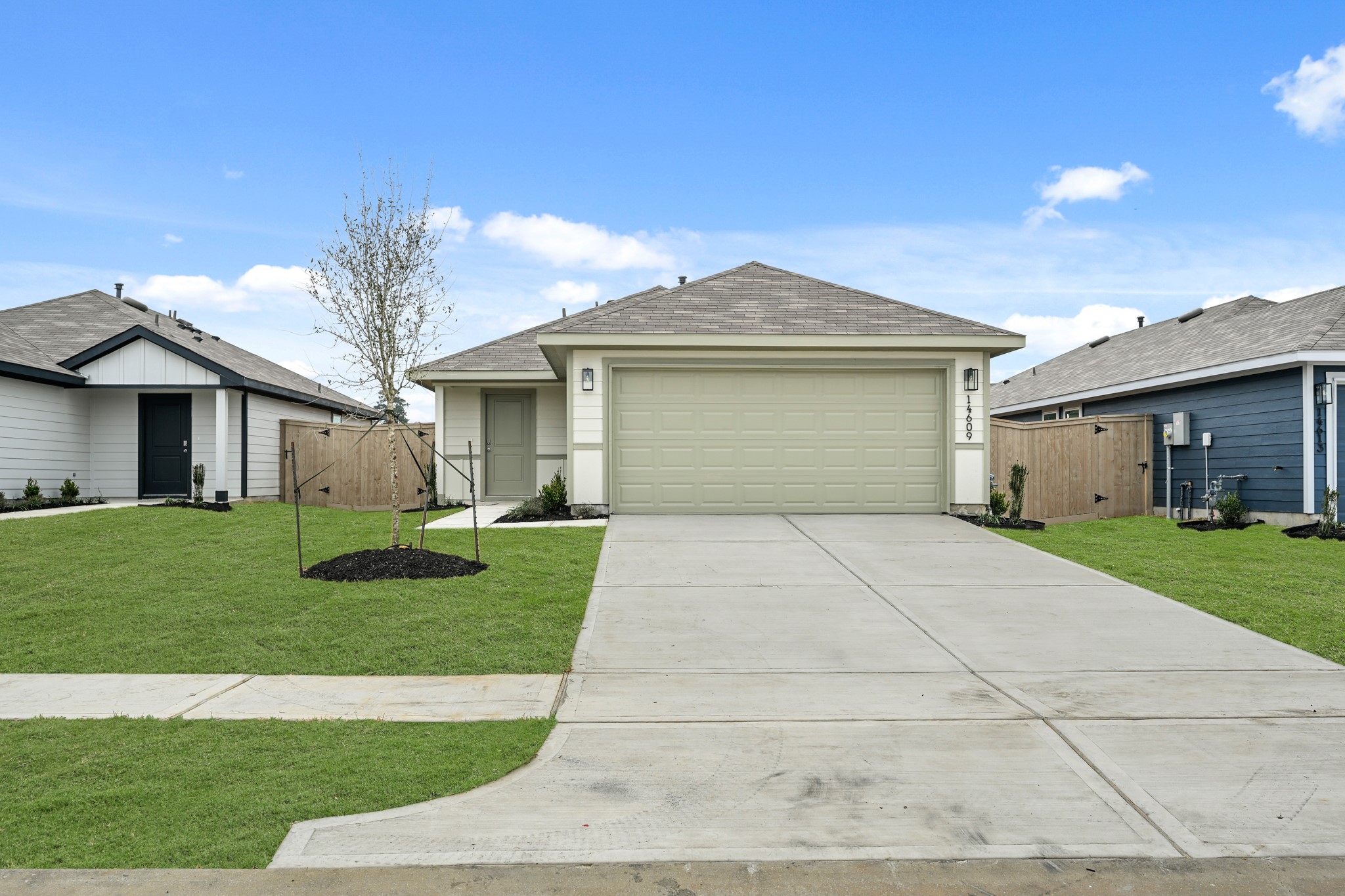 14609 Ivy Floral Way Splendora, TX 77372 - Photo 3 of 23 a front view of a house with a yard and garage