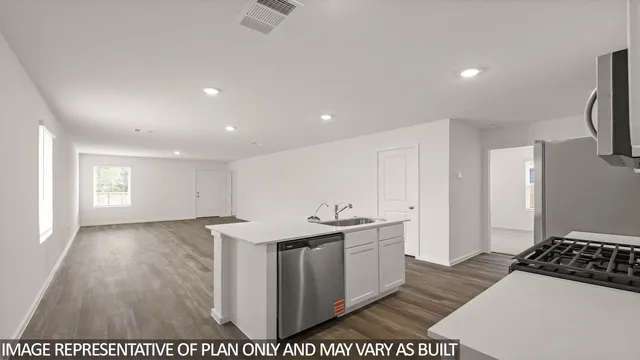 a kitchen with stainless steel appliances a stove a sink and a refrigerator