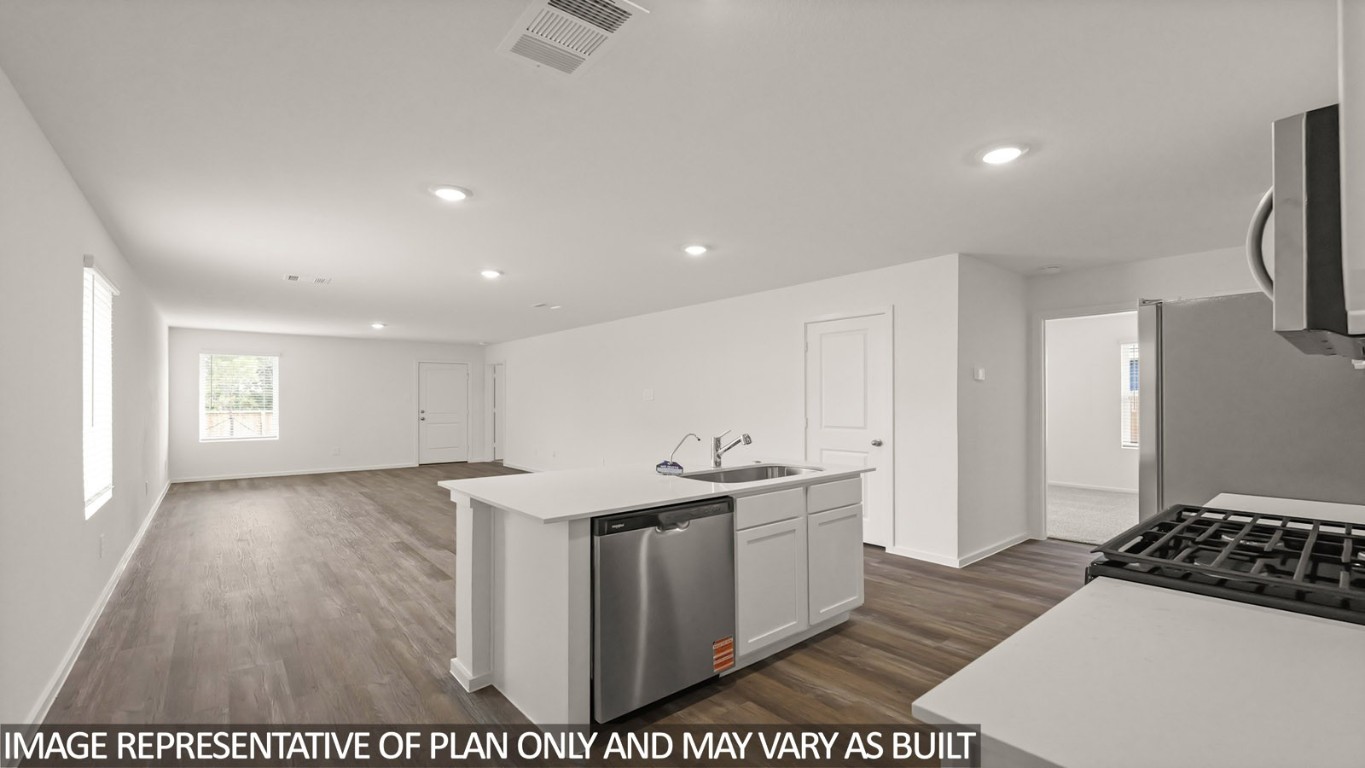 14609 Ivy Floral Way Splendora, TX 77372 - Photo 5 of 23 a kitchen with stainless steel appliances a sink a stove a refrigerator and cabinets