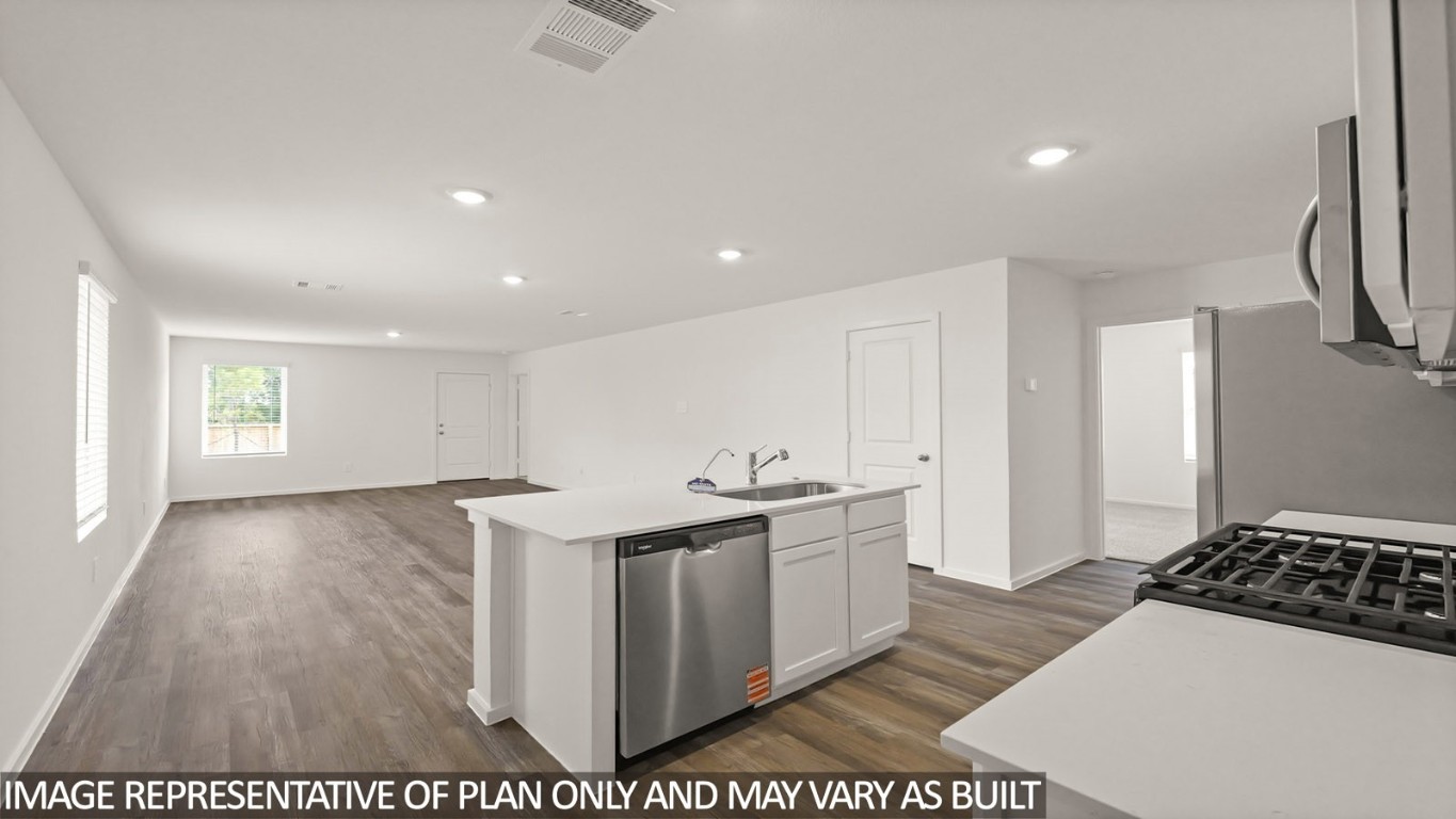 14609 Ivy Floral Way Splendora, TX 77372 - Photo 6 of 23 a kitchen with stainless steel appliances a stove a sink and a refrigerator