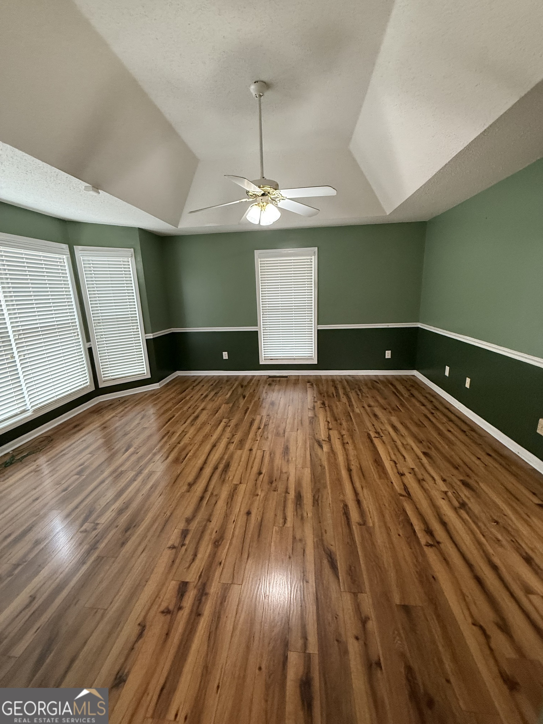 308 Deer Run Williamson, GA 30292 - Photo 23 of 35 a view of an empty room with window and wooden floor