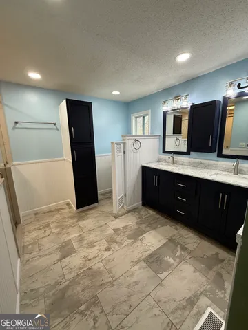 a bathroom with a double vanity sink and mirror