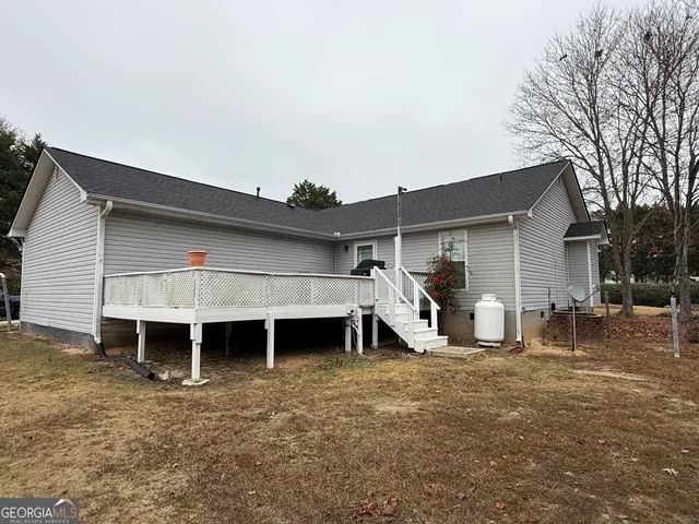 a view of a house with a yard and chair