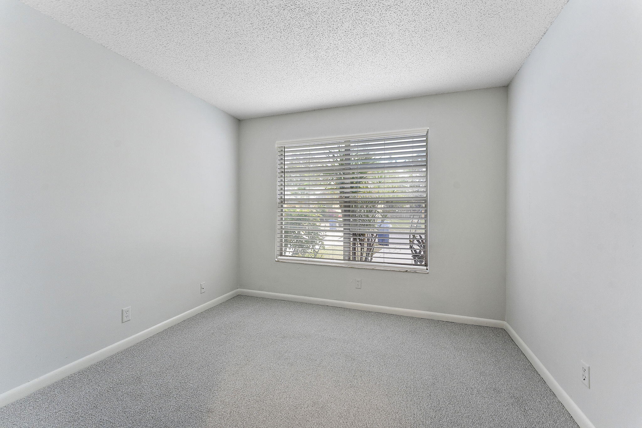 115 Oakwood Drive Jupiter, FL 33458 - Photo 11 of 21 a view of an empty room with a window