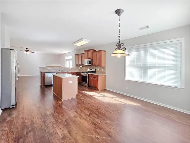 a kitchen with stainless steel appliances granite countertop a stove top oven and sink