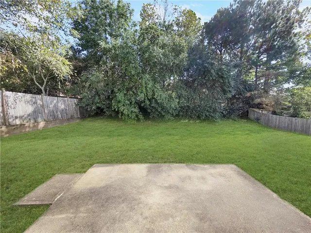 a view of a backyard with large trees