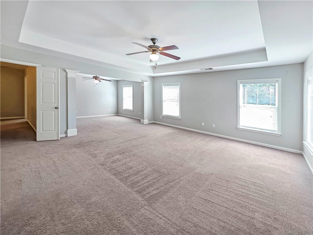5425 Fieldfreen Drive Cumming, GA 30028 - Photo 31 of 51 an empty room with chandelier fan and windows