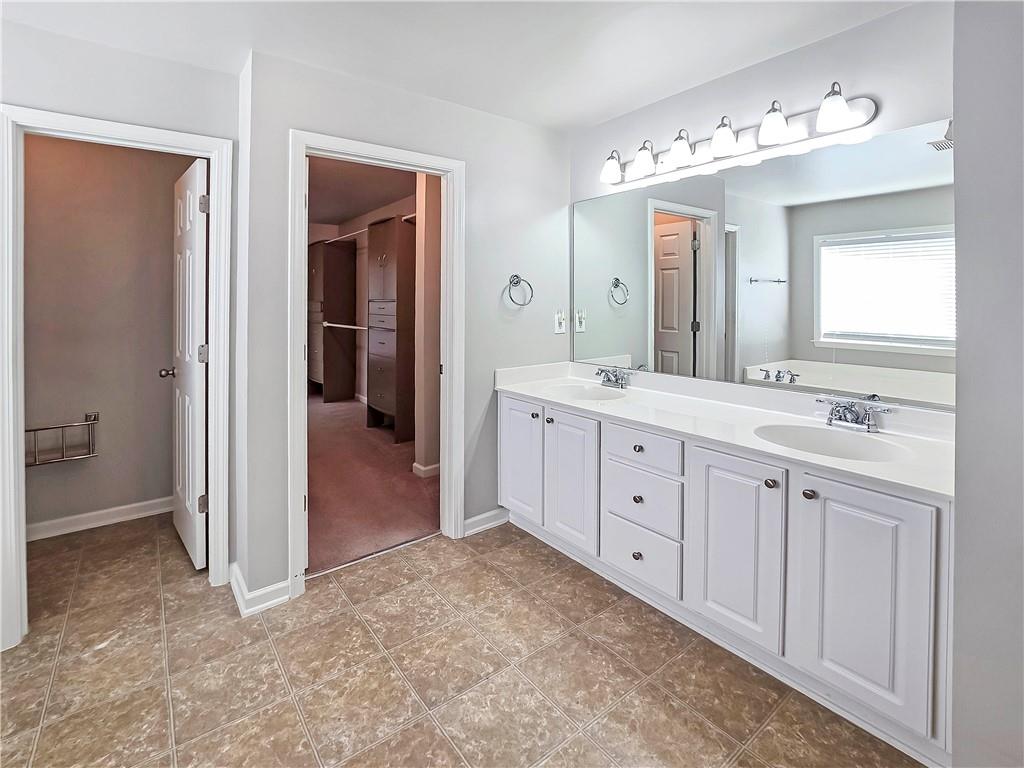5425 Fieldfreen Drive Cumming, GA 30028 - Photo 34 of 51 a spacious bathroom with a double vanity sink mirror and bathtub