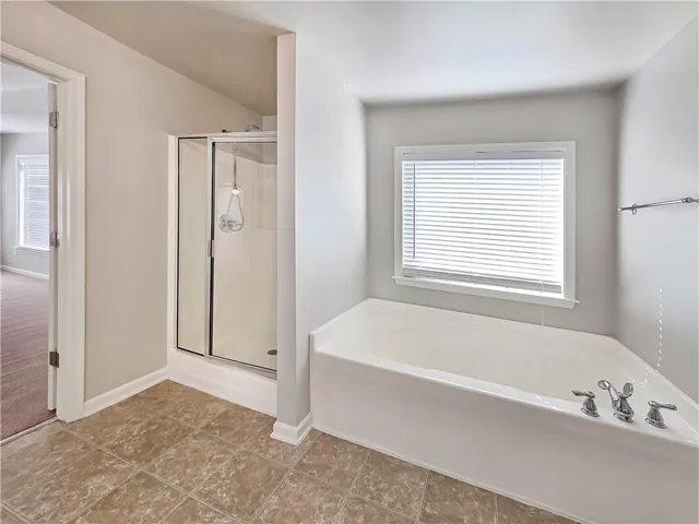 a bathroom with a bathtub and a shower