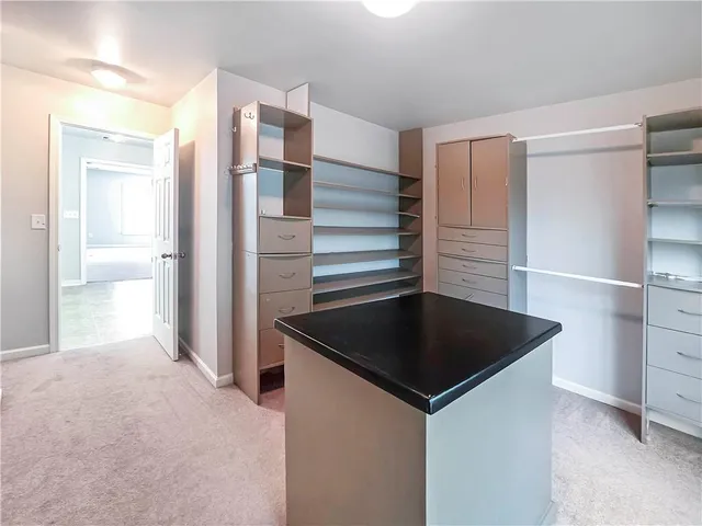 a kitchen view with granite countertop a refrigerator and a sink