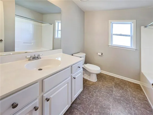 a bathroom with a sink toilet and a mirror