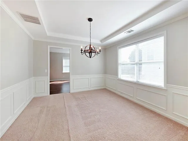 an empty room with windows and ceiling fan