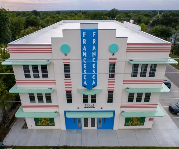 a aerial view of residential houses with yard and mountain view in back