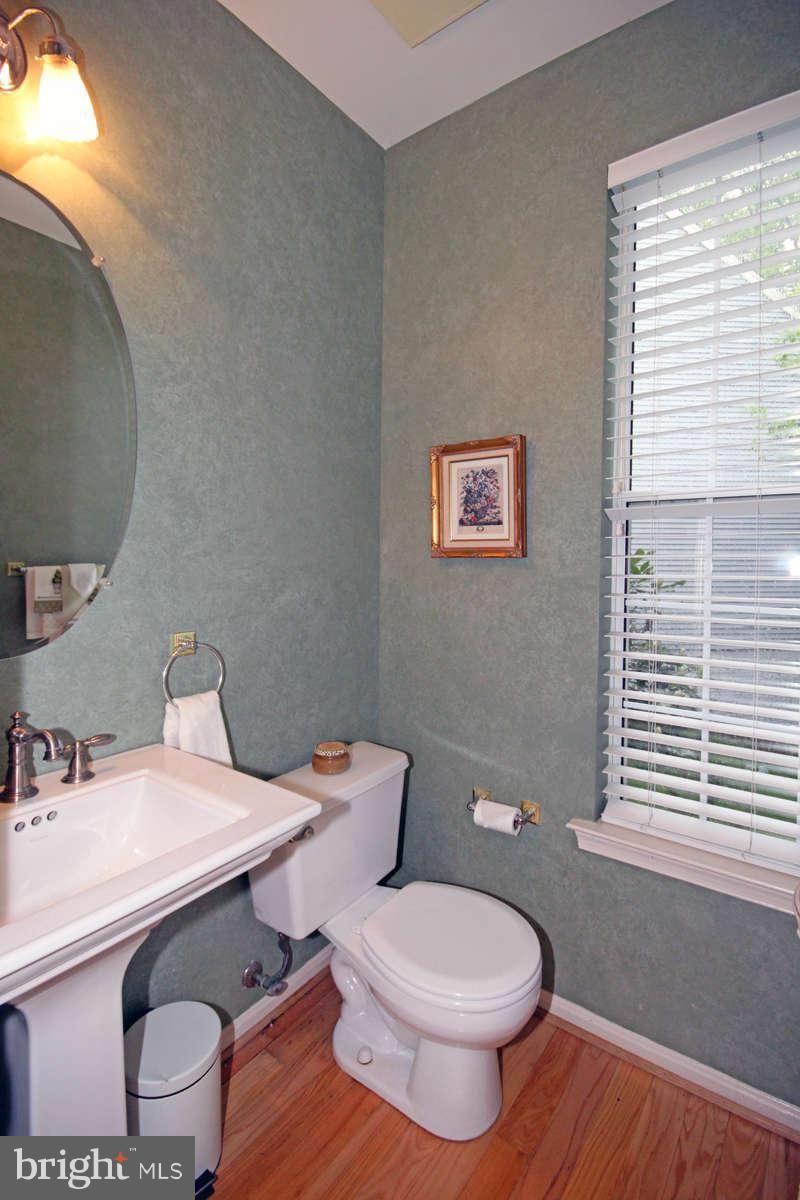 9801 Cresence Way Fairfax, VA 22032 - Photo 14 of 30 a white toilet sitting next to a bathroom sink