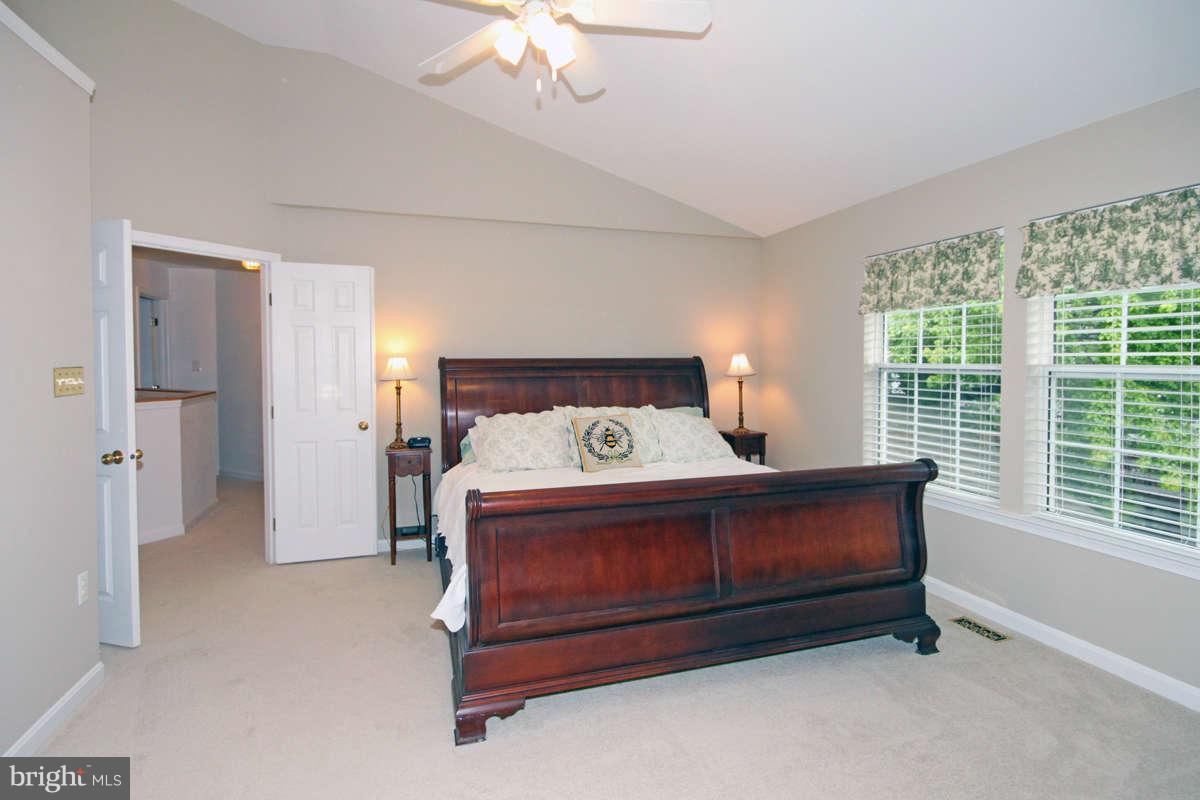 9801 Cresence Way Fairfax, VA 22032 - Photo 15 of 30 a bed sitting in a room next to a window