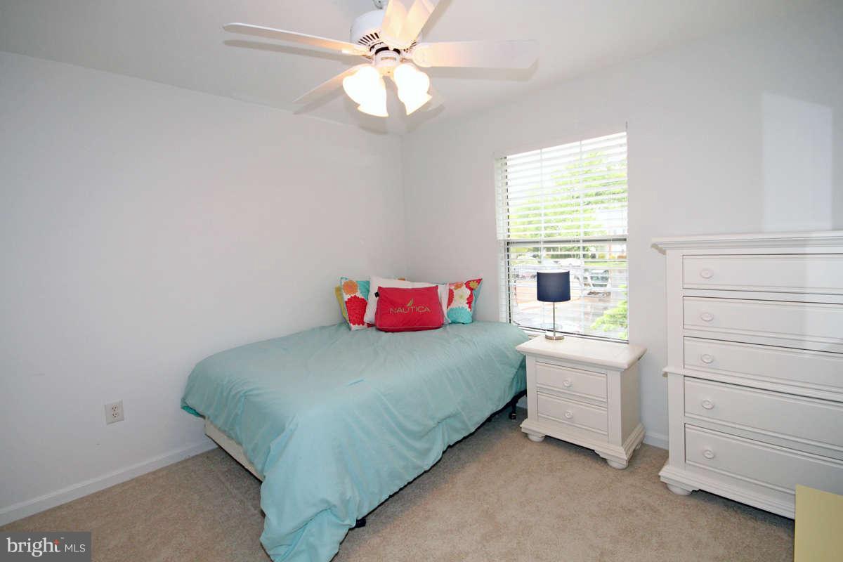 9801 Cresence Way Fairfax, VA 22032 - Photo 19 of 30 a bedroom with a bed and a chandelier