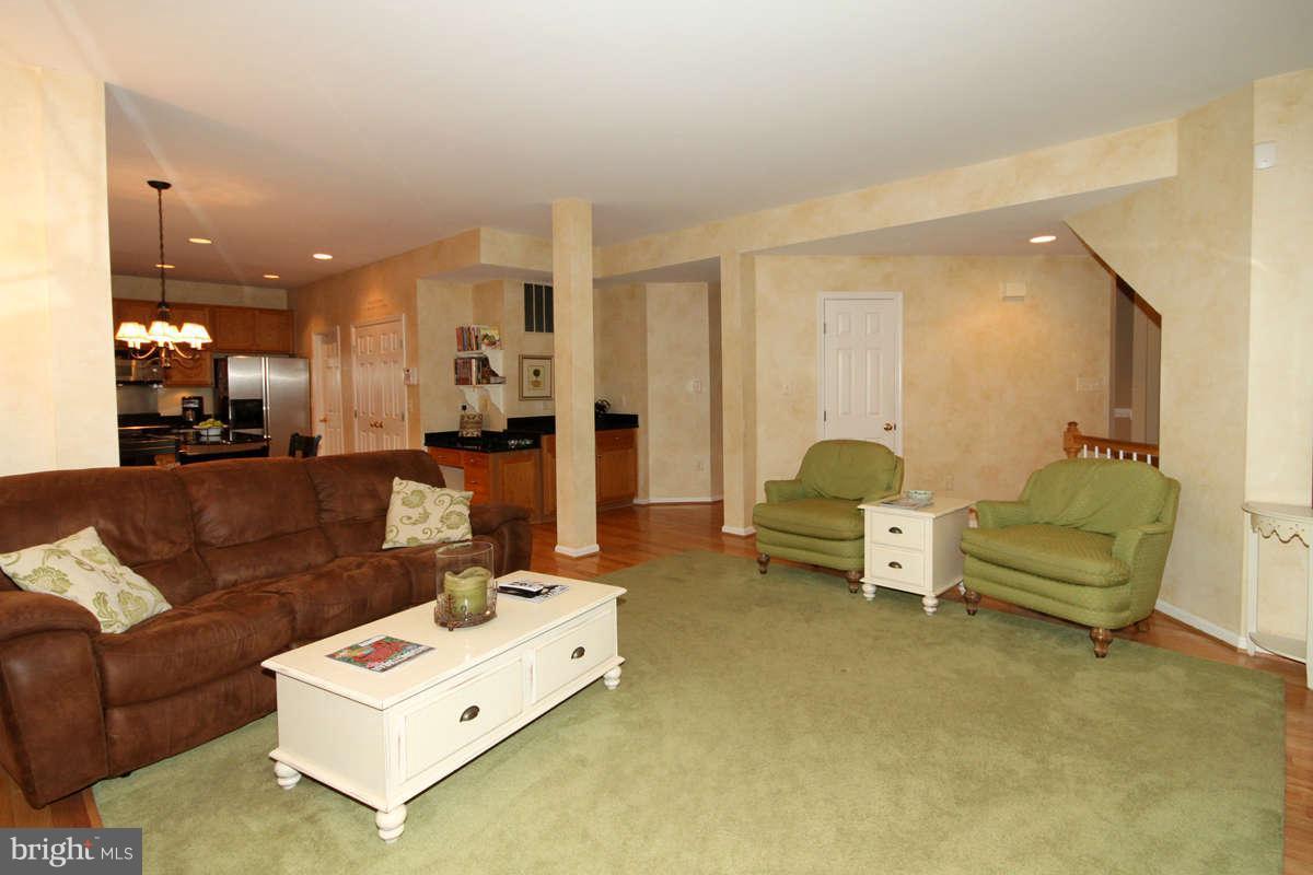 9801 Cresence Way Fairfax, VA 22032 - Photo 7 of 30 a living room with furniture and a chandelier
