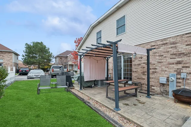 a front view of a house with garden and sitting area