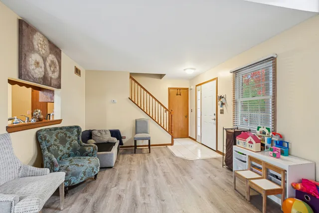 a living room with furniture and wooden floor