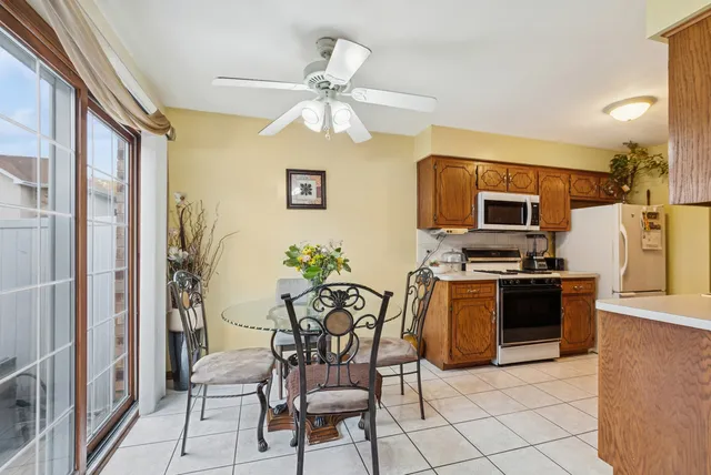 a kitchen with stainless steel appliances kitchen island granite countertop a refrigerator and a stove top oven