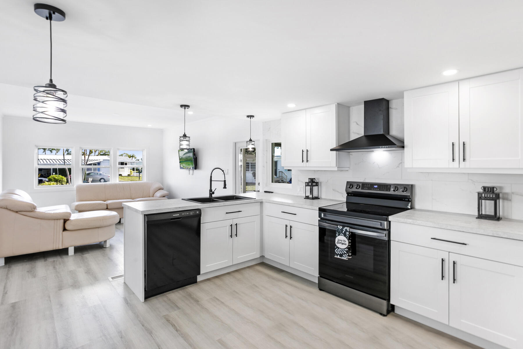 3003 Bimini Bay Boynton Beach, FL 33436 - Photo 1 of 31 a kitchen with stainless steel appliances granite countertop a sink dishwasher stove and white cabinets with wooden floor