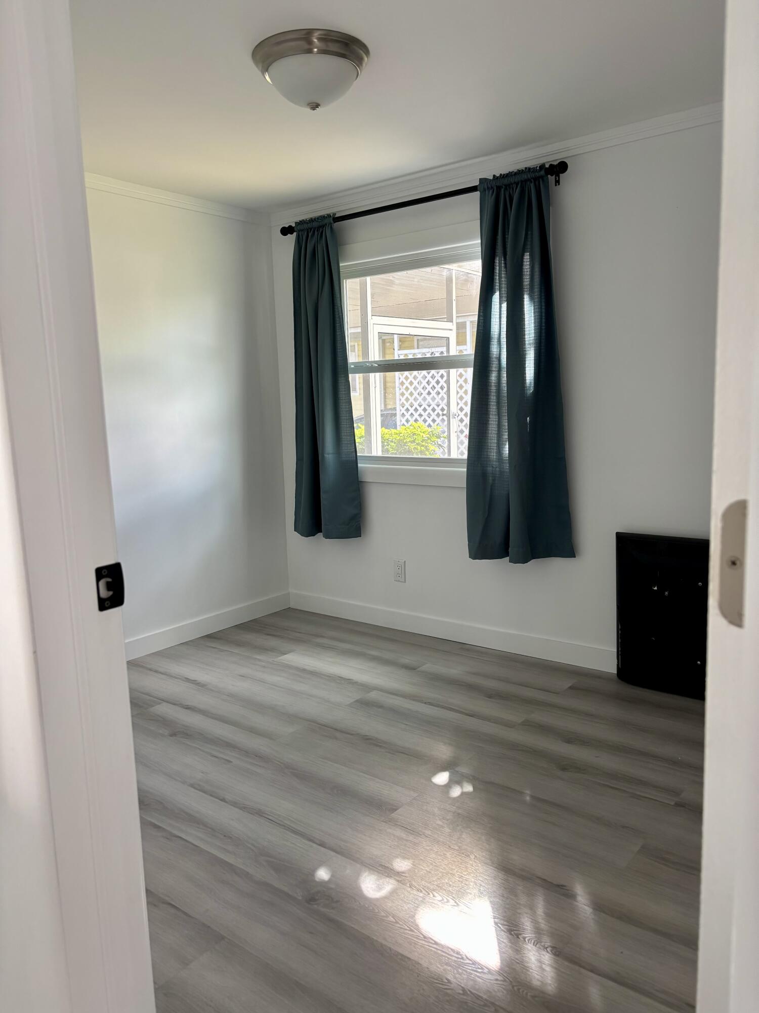 3003 Bimini Bay Boynton Beach, FL 33436 - Photo 14 of 31 a view of an empty room with wooden floor and a window
