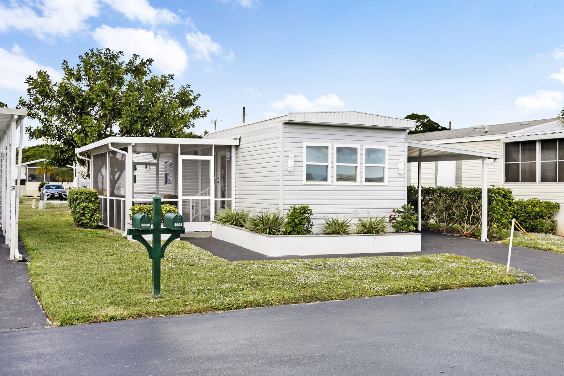 3003 Bimini Bay Boynton Beach, FL 33436 - Photo 16 of 31 a front view of a house with a yard and table