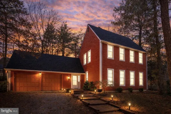 a front view of a building with a yard