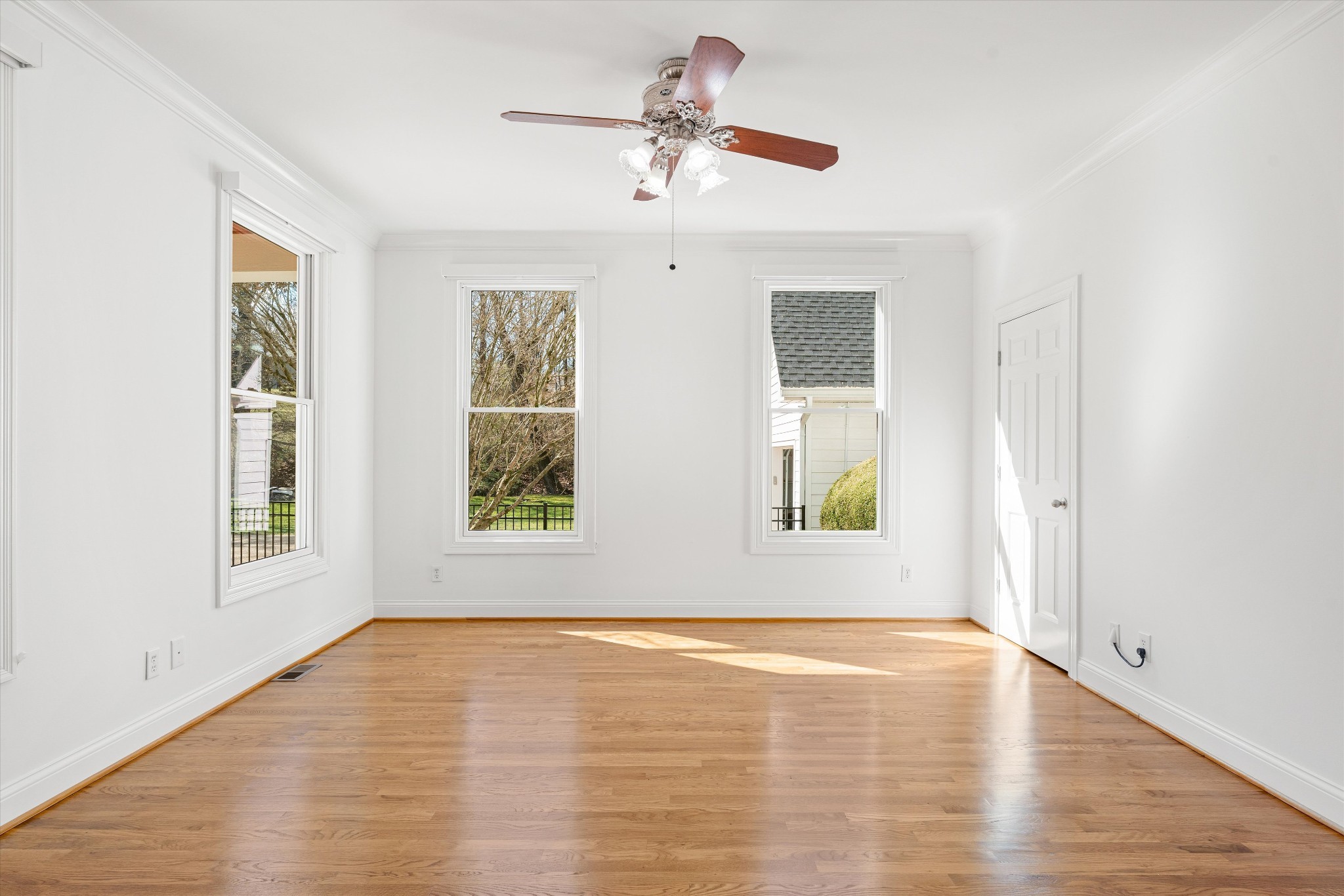 3863 Saundersville Ferry Road Mount Juliet, TN 37122 - Photo 16 of 83 an empty room with wooden floor chandelier fan and windows