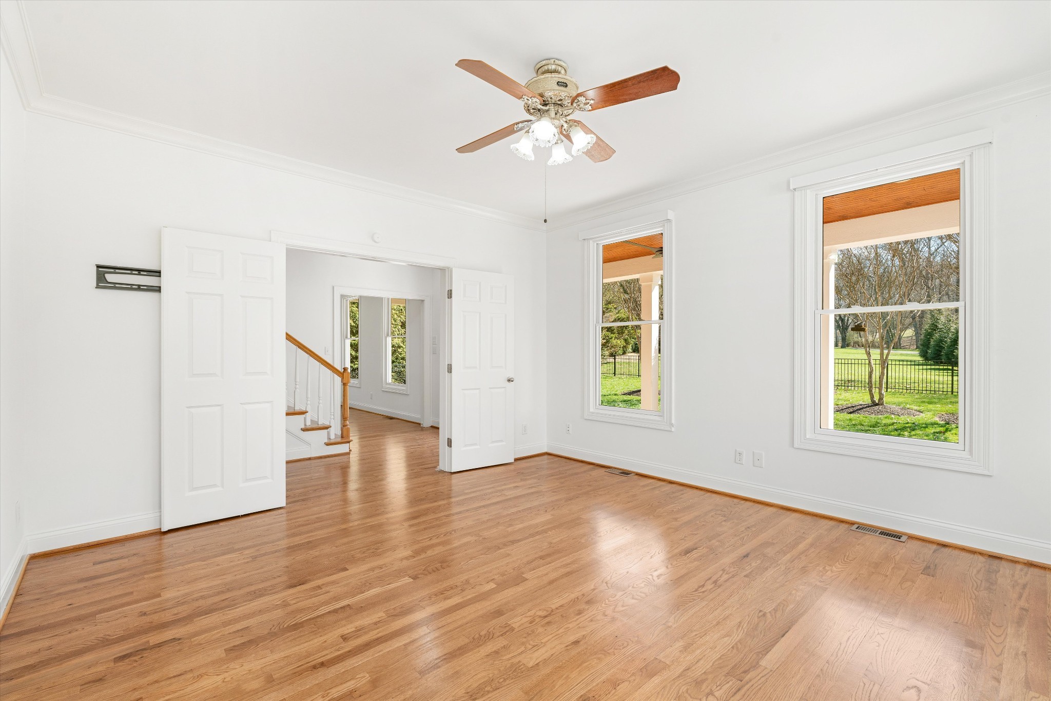 3863 Saundersville Ferry Road Mount Juliet, TN 37122 - Photo 17 of 83 an empty room with wooden floor a ceiling fan and windows