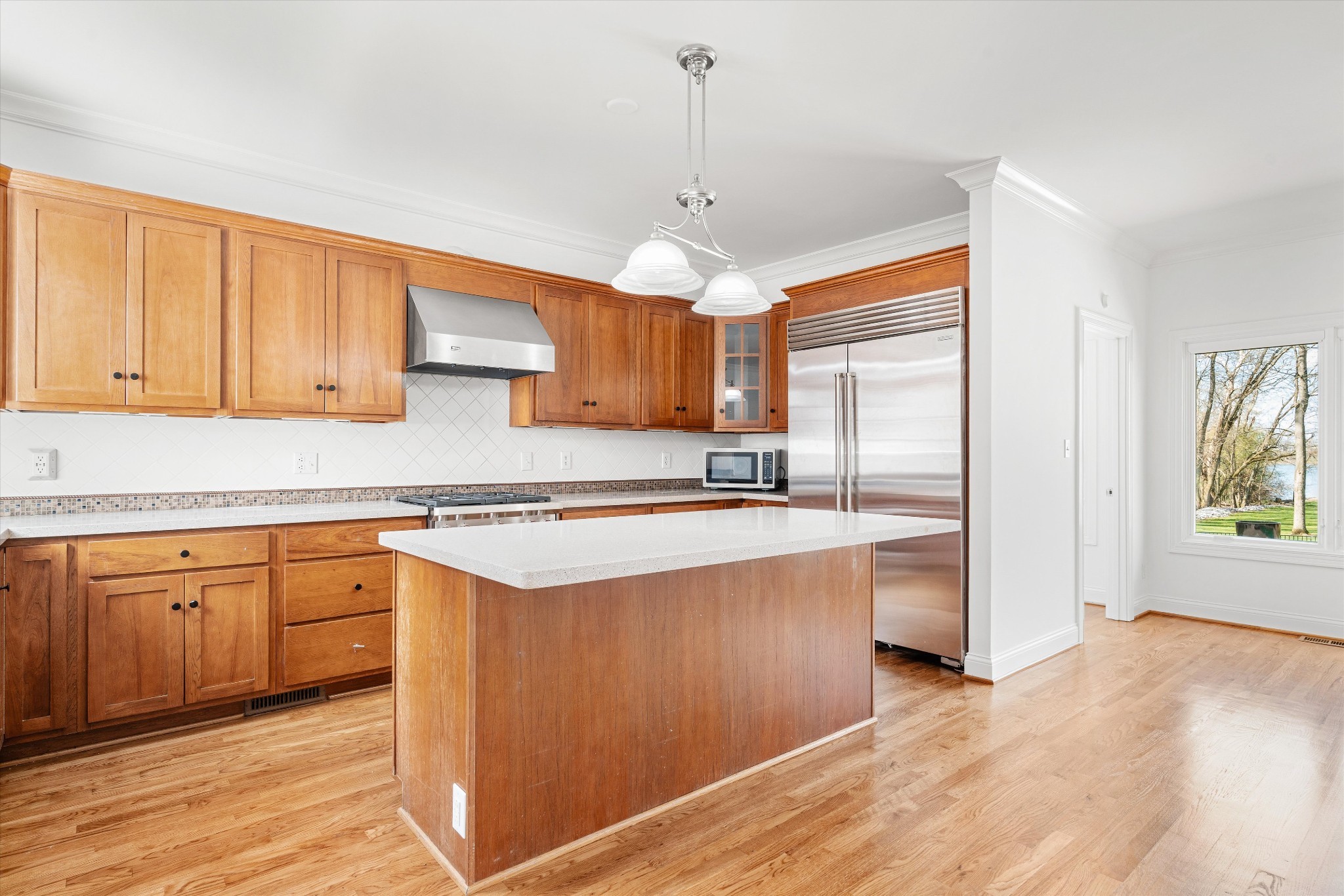 3863 Saundersville Ferry Road Mount Juliet, TN 37122 - Photo 27 of 83 a kitchen with stainless steel appliances granite countertop a sink a stove a refrigerator and island with wooden floor