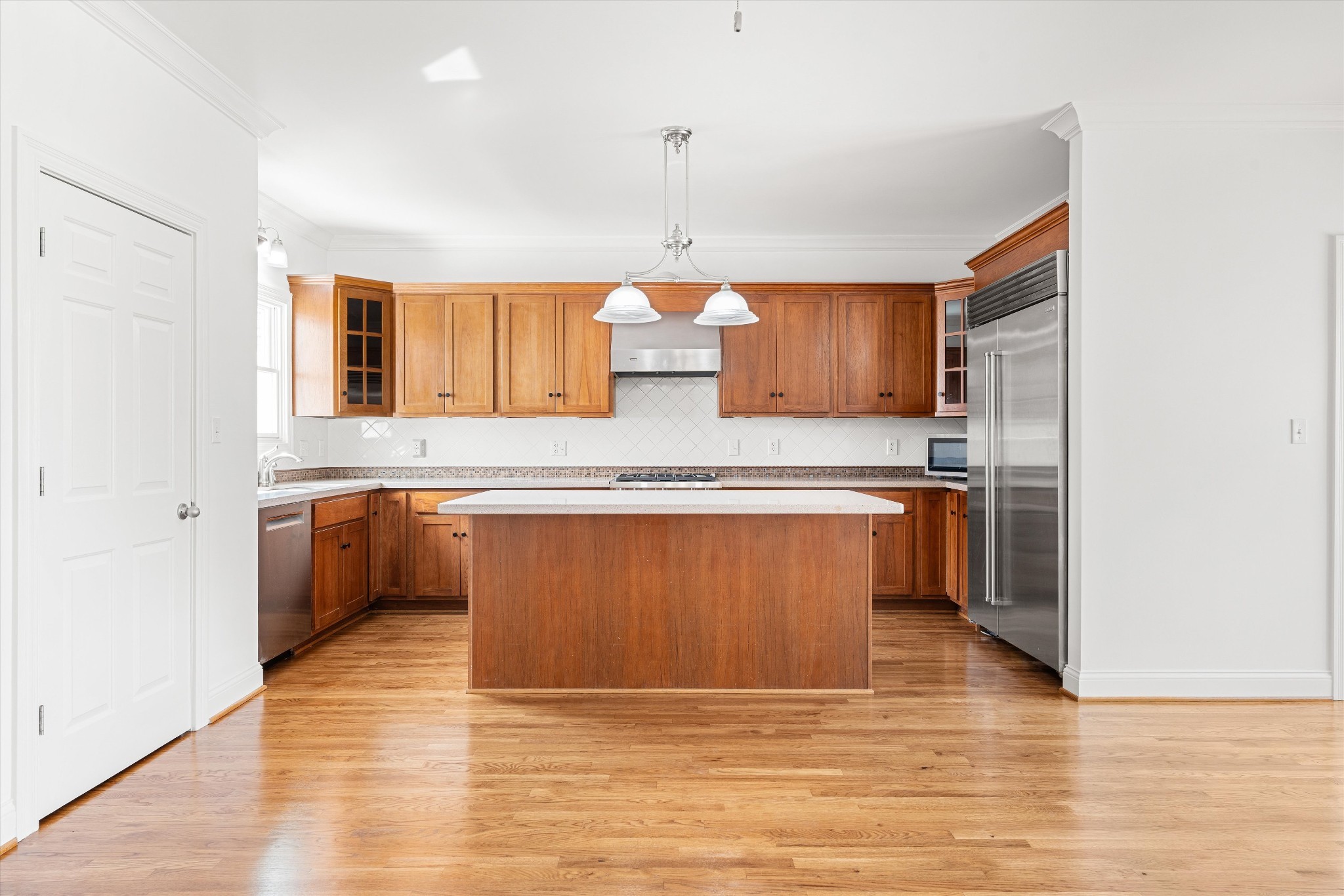 3863 Saundersville Ferry Road Mount Juliet, TN 37122 - Photo 29 of 83 a kitchen with stainless steel appliances granite countertop a sink counter space cabinets and wooden floor