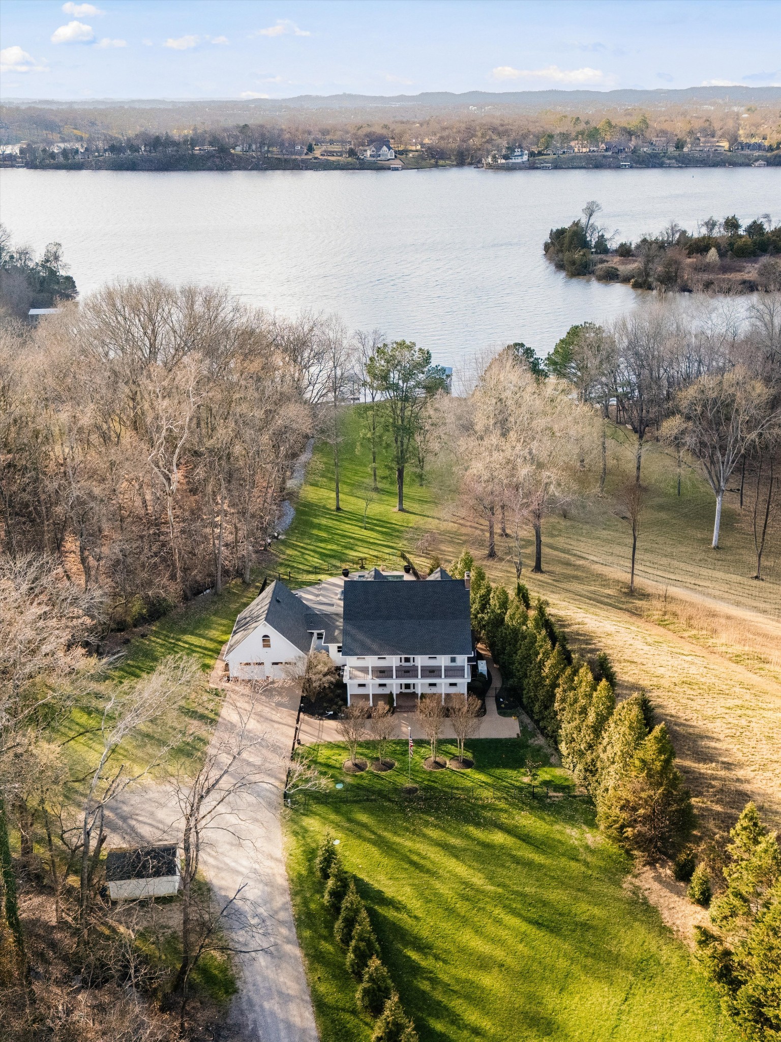 3863 Saundersville Ferry Road Mount Juliet, TN 37122 - Photo 68 of 83 a view of a lake with a yard and a large window