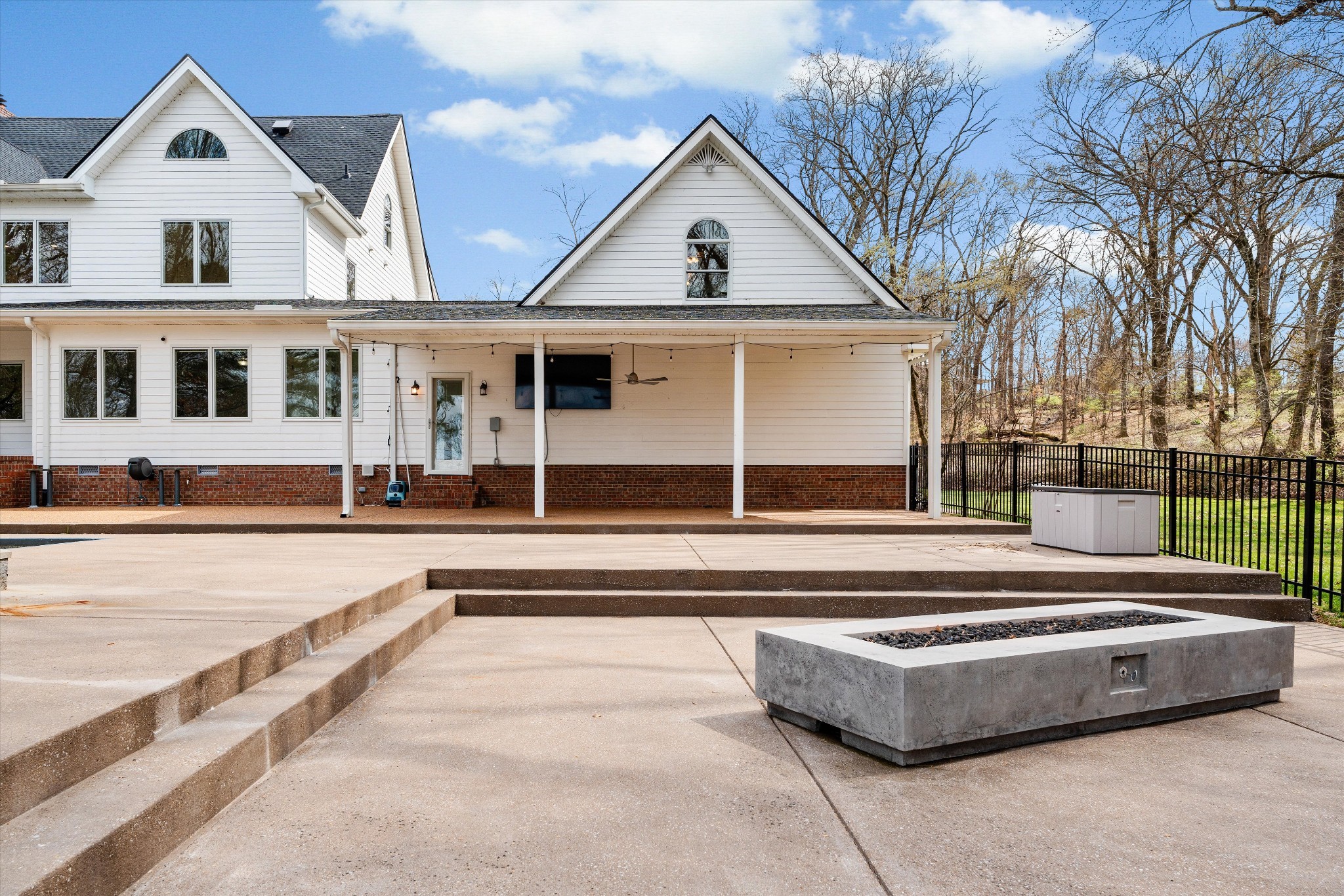 3863 Saundersville Ferry Road Mount Juliet, TN 37122 - Photo 78 of 83 a view of a white house with a large windows next to a road with large trees
