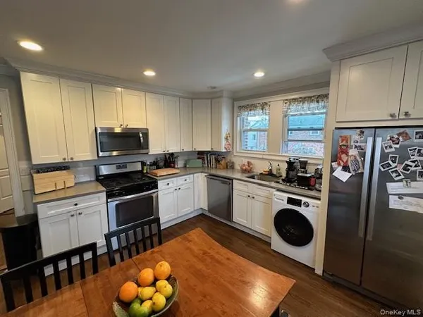 a kitchen with a sink appliances and cabinets