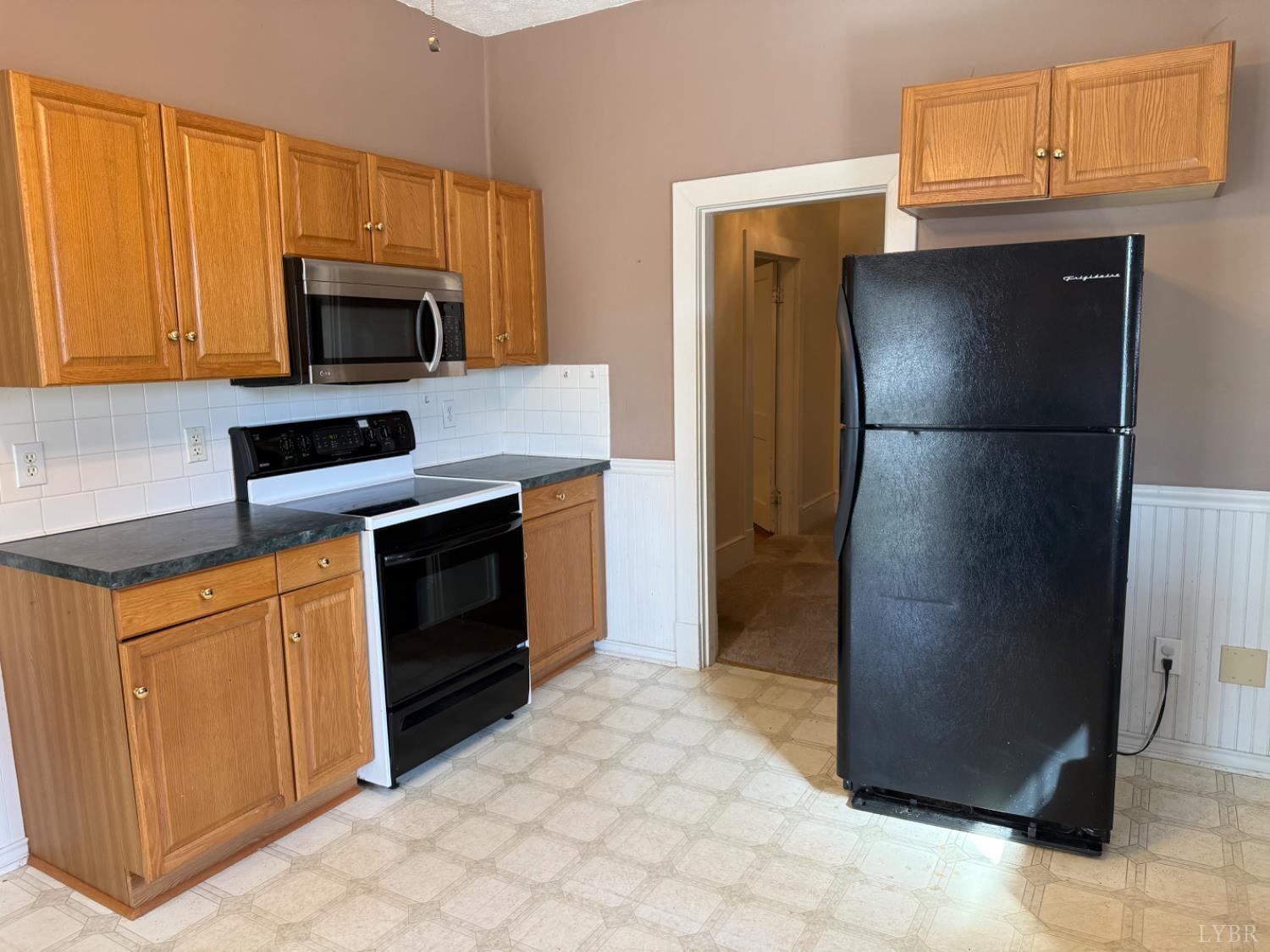 1431 High Peak Road Monroe, VA 24574 - Photo 11 of 24 a kitchen with stainless steel appliances granite countertop a refrigerator stove and microwave