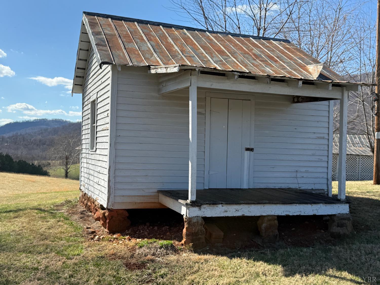 1431 High Peak Road Monroe, VA 24574 - Photo 3 of 24 a view of a small house with wooden fence