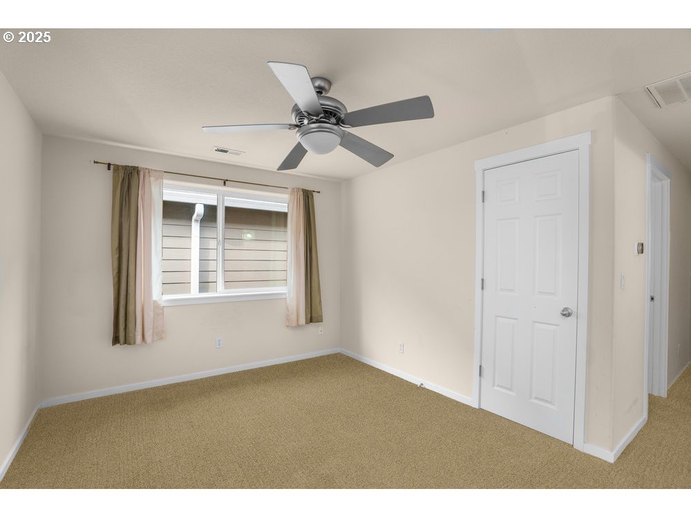 515 Northeast Suttle Street Portland, OR 97211 - Photo 13 of 28 a view of an empty room with a window