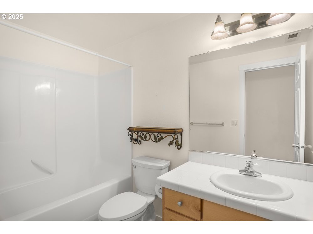 515 Northeast Suttle Street Portland, OR 97211 - Photo 18 of 28 a bathroom with a sink a toilet and mirror