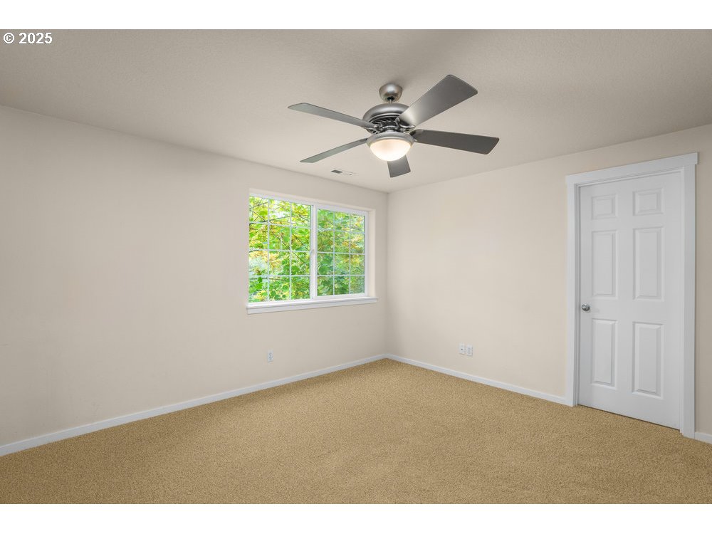 515 Northeast Suttle Street Portland, OR 97211 - Photo 20 of 28 an empty room with a window and a fan