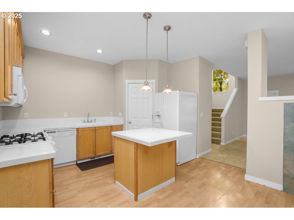 515 Northeast Suttle Street Portland, OR 97211 - Photo 6 of 28 a kitchen with a stove a refrigerator and a sink