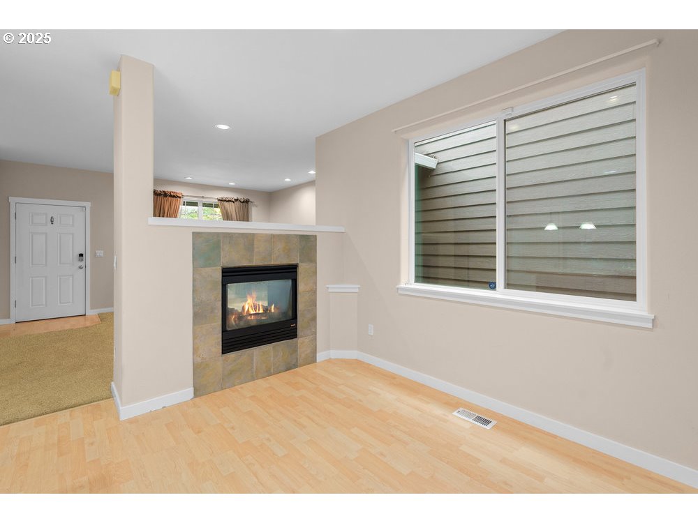 515 Northeast Suttle Street Portland, OR 97211 - Photo 10 of 28 a view of an empty room with a window and fire place